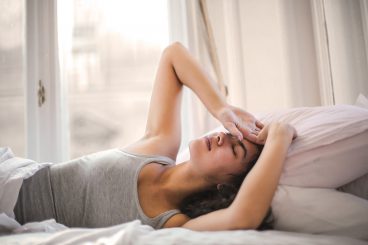 Woman In Gray Tank Top Lying On Bed 3768582