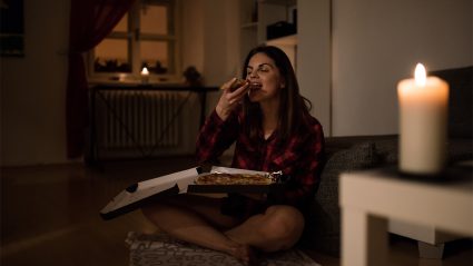 Hungry Woman Having A Slice Of Pizza