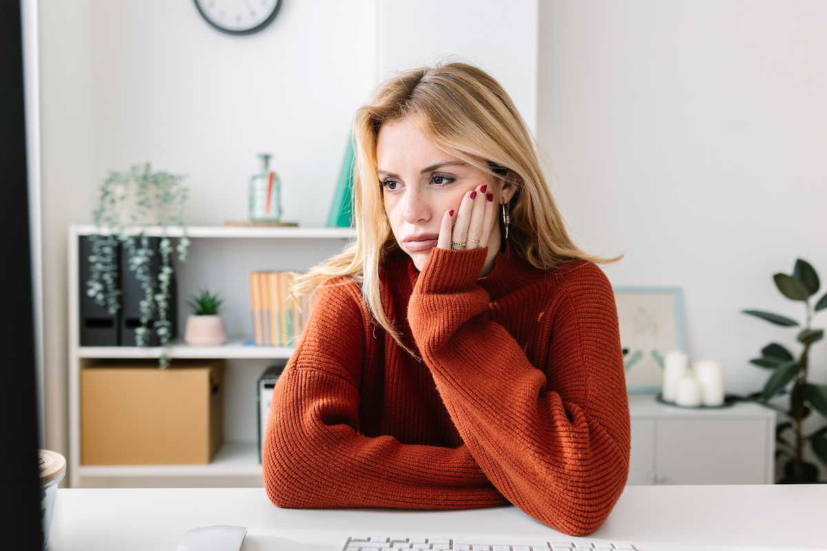 Worried Young Adult Woman Receiving Bad News On Desktop Computer.