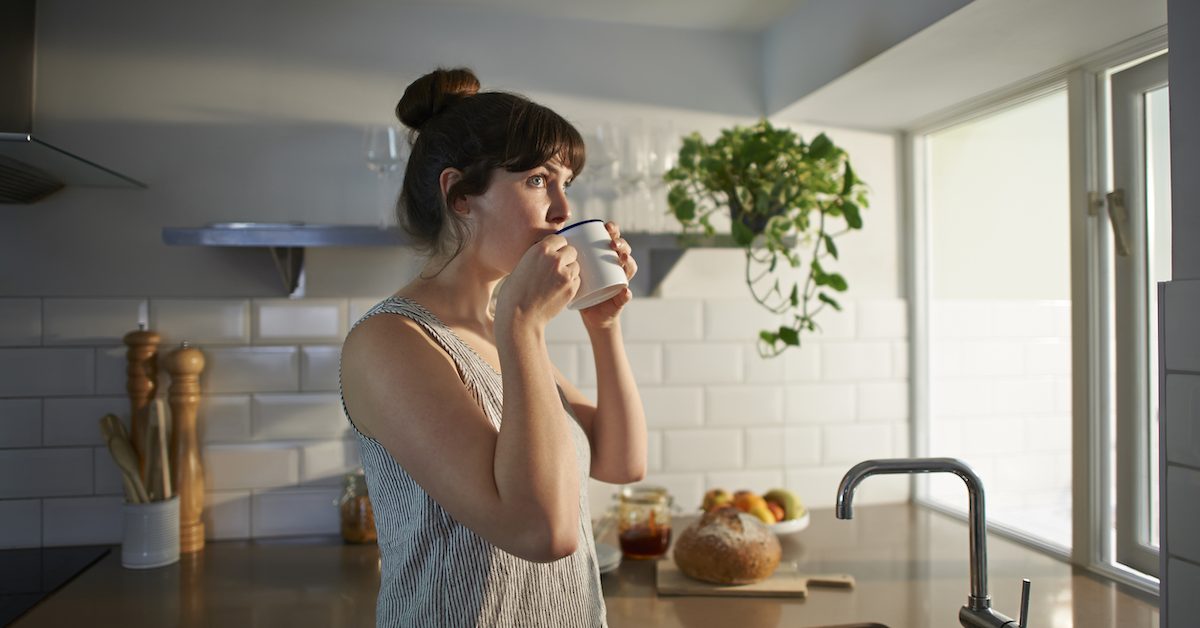 Woman Drinking From Mug In Zero Waste Kitchen.