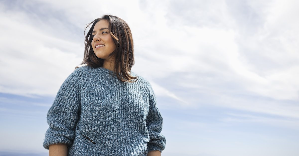 Portrait Of Young Woman Standing Against Sky On Sunny Day