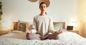 Calm, Meditation And Woman In Bedroom, Peace And Relax On Bed, Spiritual And Enlightenment In House. Mindset, Zen And Emotional Health With Chakra, Wellness And Person In Morning, Breathing And Home