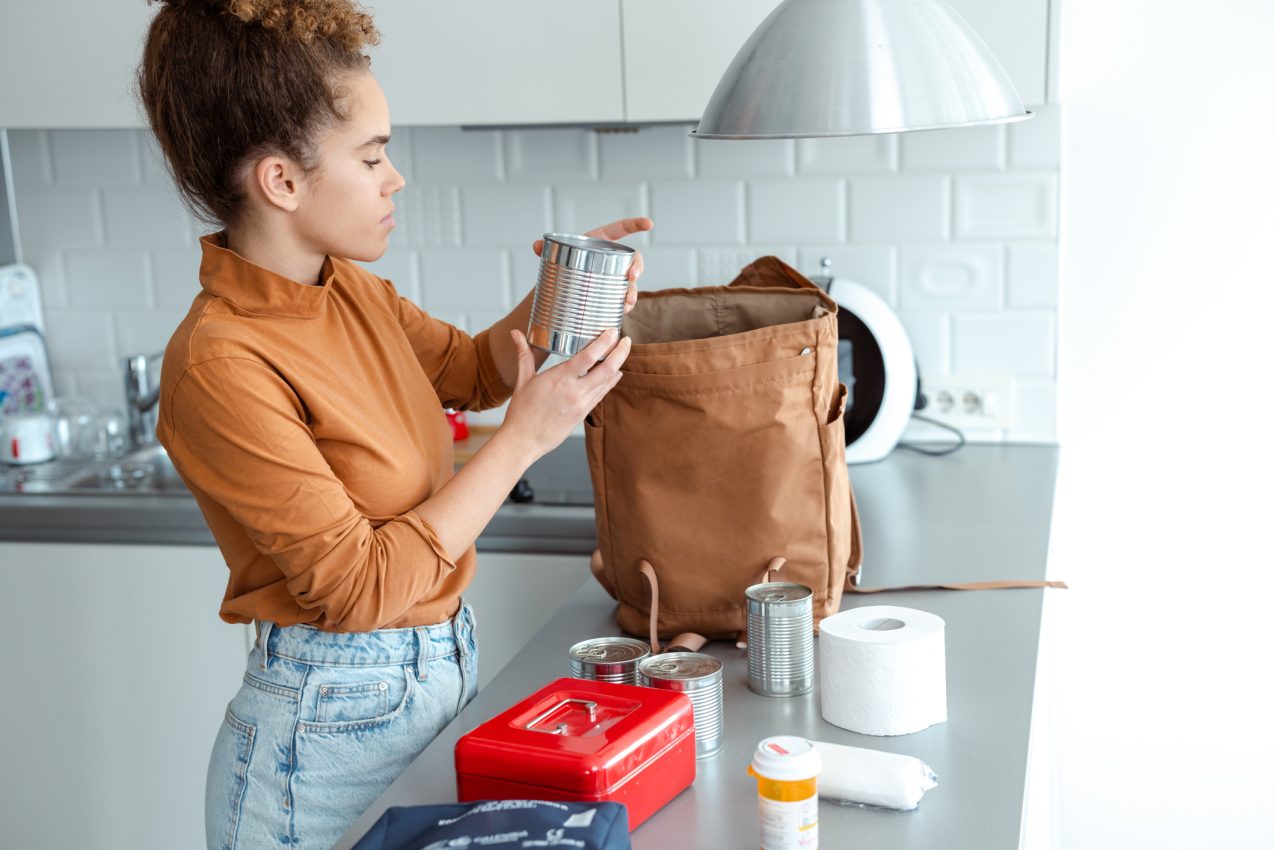 Woman Organizing Emergency Supplies In The Kitchen For Preparedness