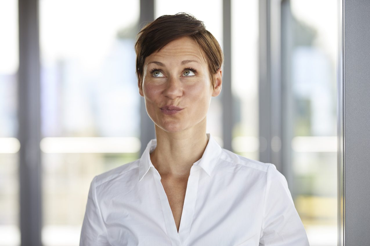 Portrait Of Businesswoman In Office Pouting Looking Up