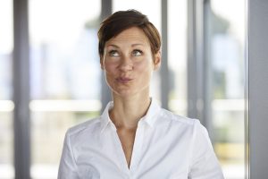 Portrait Of Businesswoman In Office Pouting Looking Up