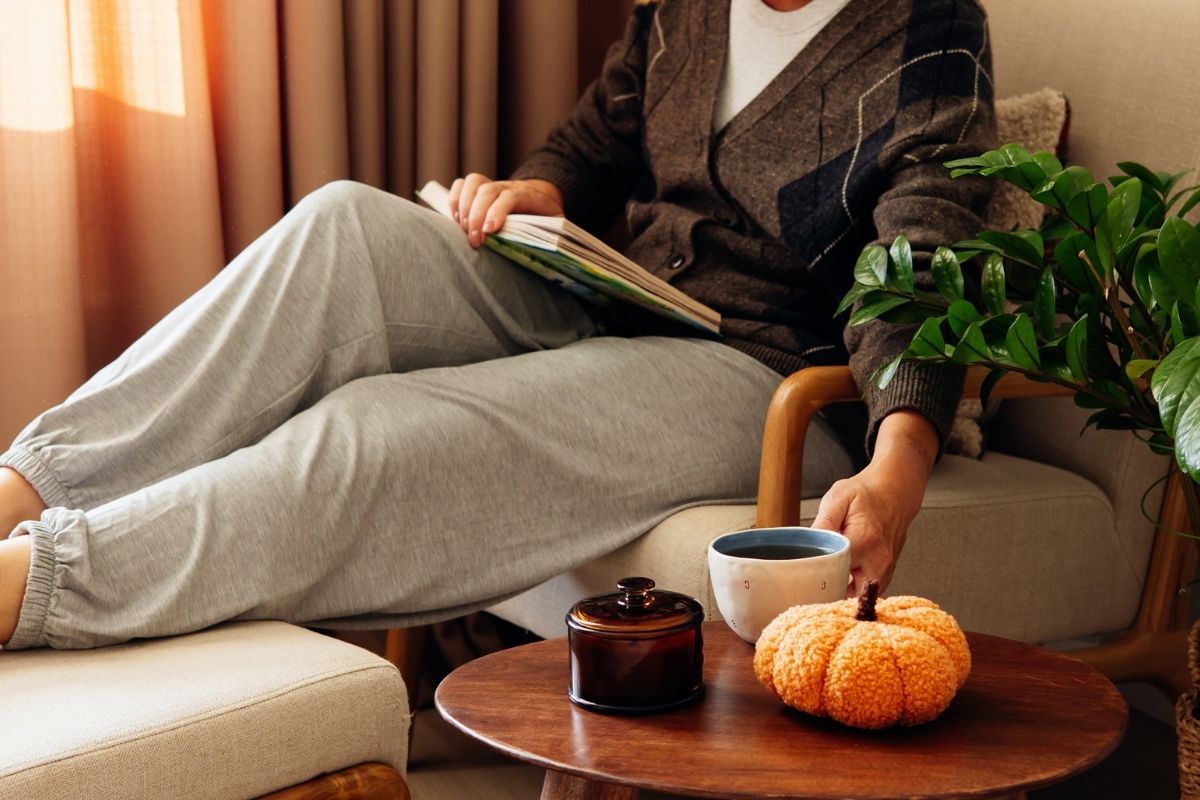 Vrouw met een kop thee - herfstsfeer in huis